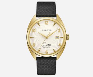 bulova-frank-sinatra-watch Norman Hege Jewelers | Gold Bulova watch with a leather band against a white background